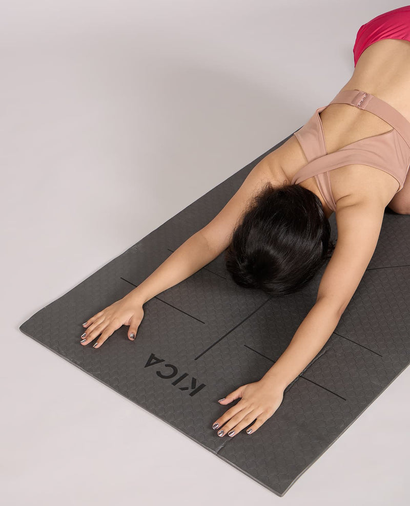 Person practicing yoga on a KICCA branded mat
