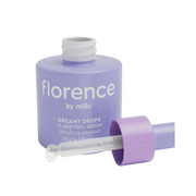 Purple serum bottle with dropper labeled 'florence by mills' on a white background