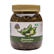 Jar of pickled jalapeños with a gold lid on a white background