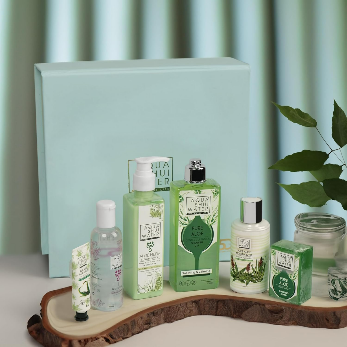 Collection of green skincare products on a wooden tray with a light blue background