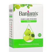 Banjaras hair care powder packaging with amla illustration on a white background