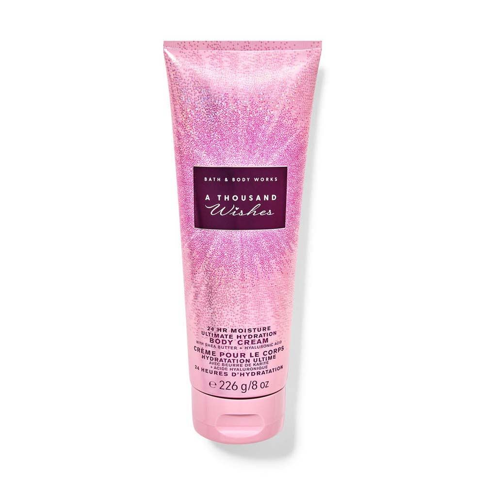 Pink glittery body cream tube with 'A Thousand Wishes' label on a white background
