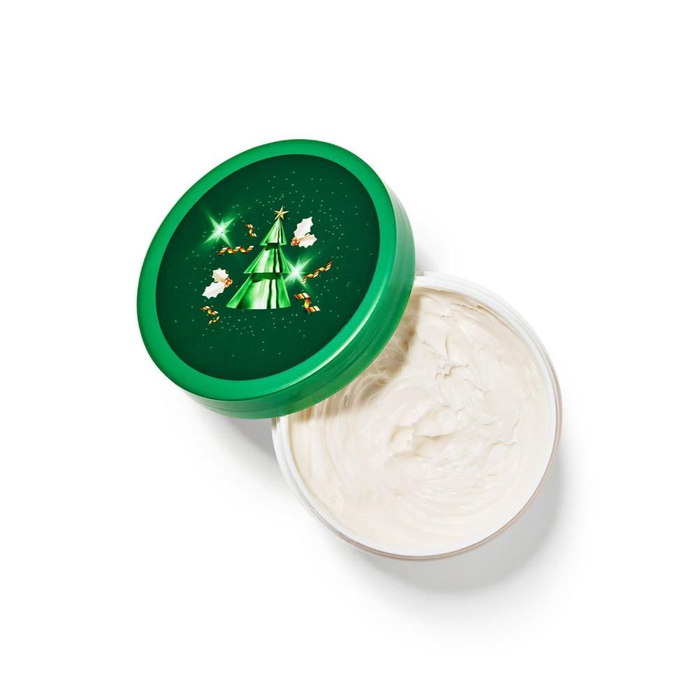 Cosmetic product with green lid featuring a Christmas tree design on a white background