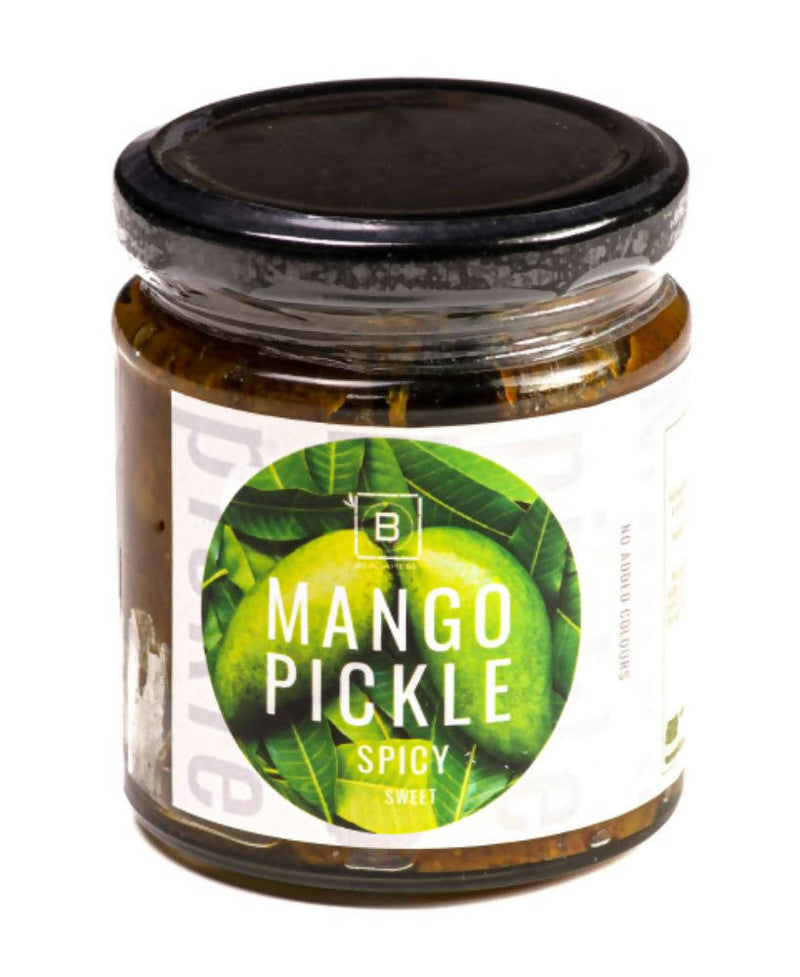 Jar of mango pickle with a black lid on a white background