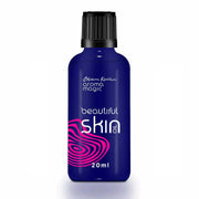 Blue bottle labeled 'beautiful skin oil' with black cap on white background