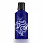 Blue bottle labeled 'Aroma Magic' for dry skin on a white background