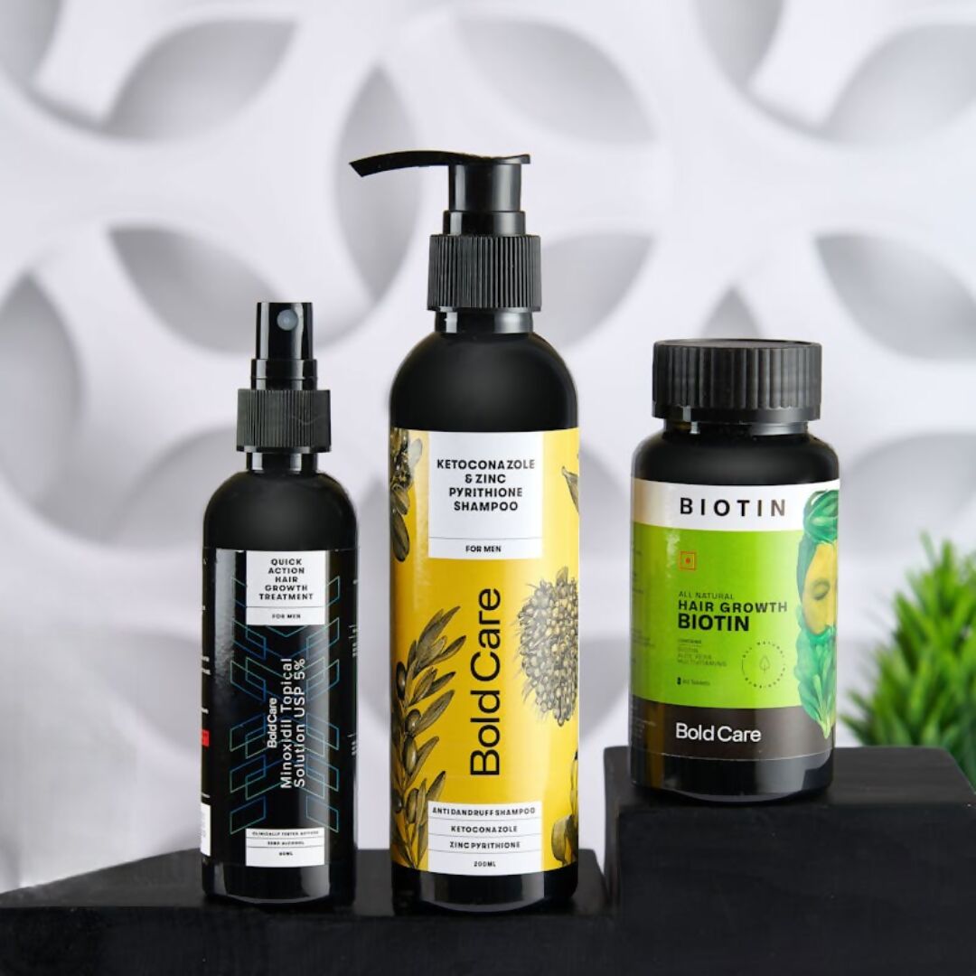 Three hair care products on a black surface with a white textured background