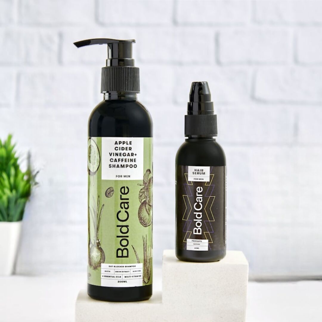 Two bottles of Bold Care hair care products on a white surface with a tiled wall background.