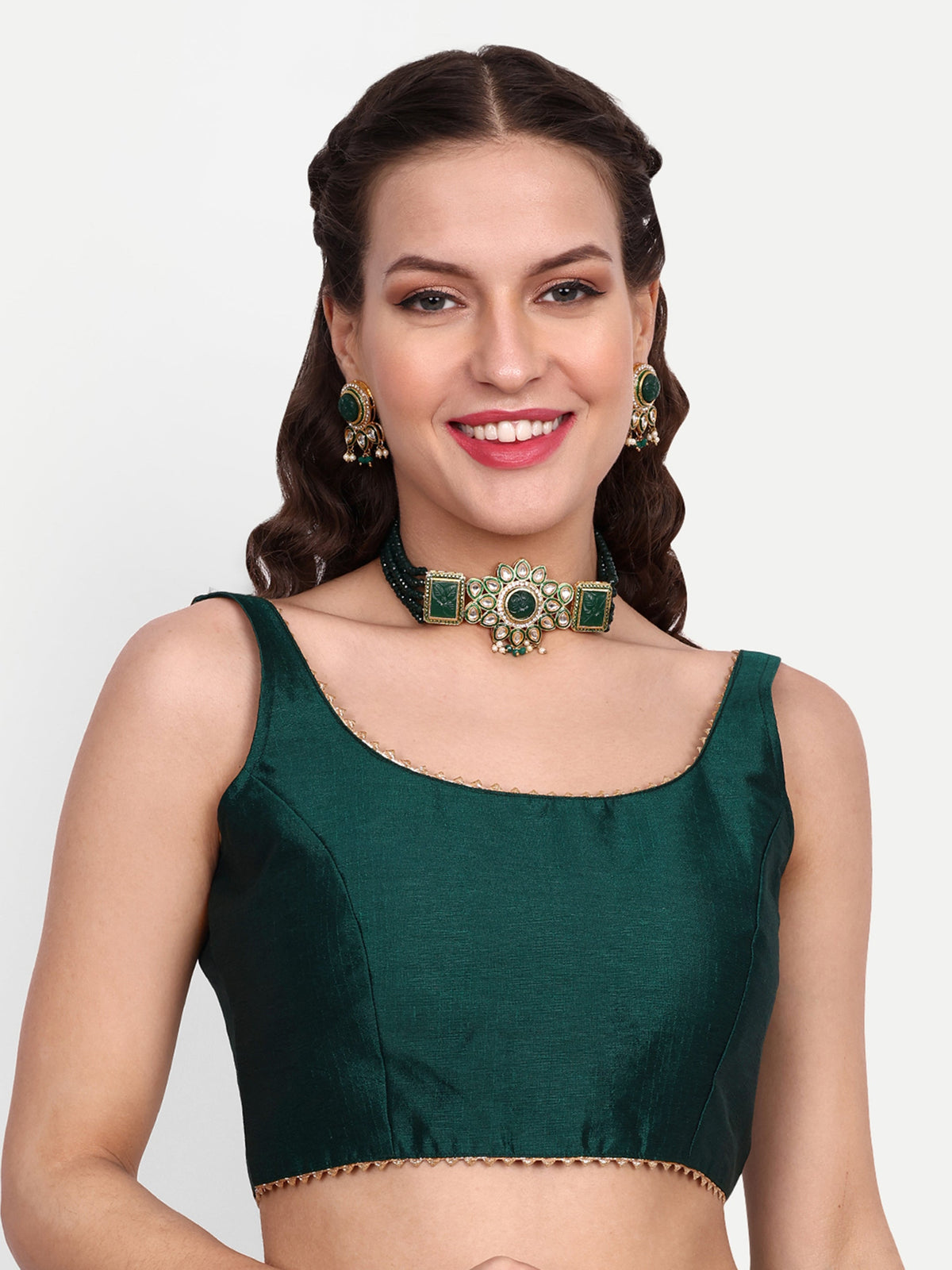 Woman wearing a green blouse with a matching choker against a white background