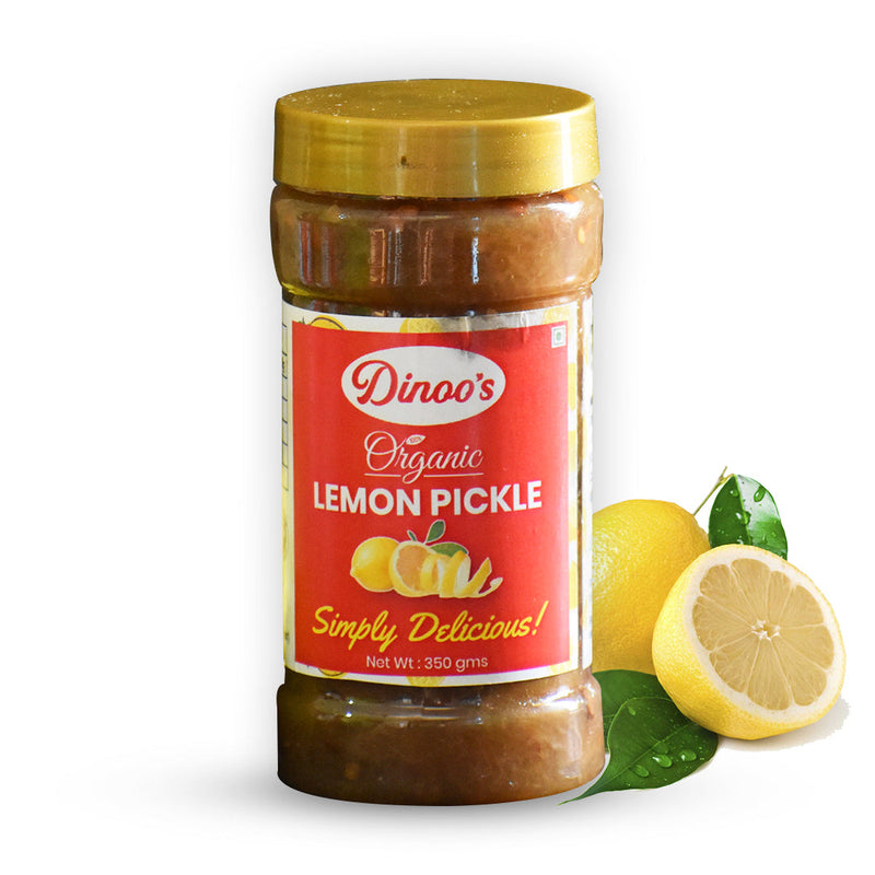 Jar of Dinoa's Organic Lemon Pickle with lemons on a white background