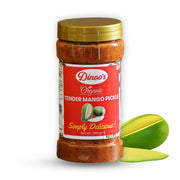 Jar of Dinoos Organic Tender Mango Pickle with a gold lid and mango slices on a white background
