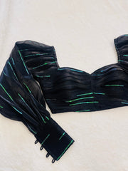 Black strapless top with green accents on a white background
