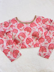 Floral patterned blouse with long sleeves on a white background