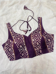 Purple patterned top on a white textured background