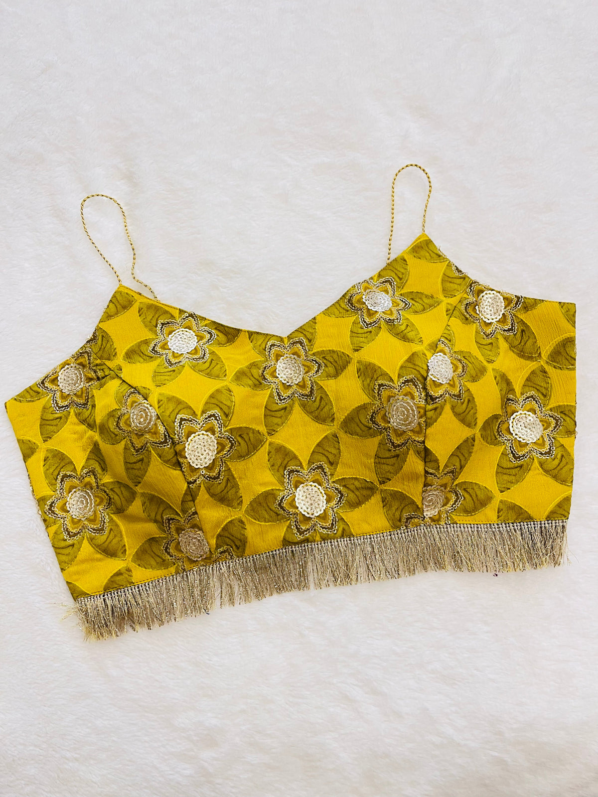 Yellow floral embroidered top with fringe on a white background