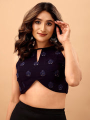 Woman wearing a black sequin top against a beige background