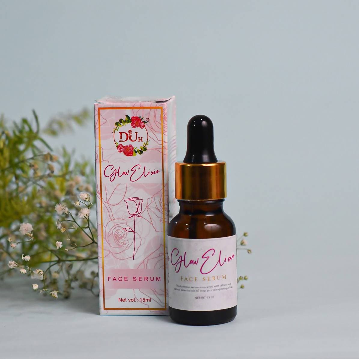 Glow Elise face serum bottle and packaging on a light background with greenery.