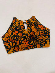 Orange and black floral patterned top on a white background