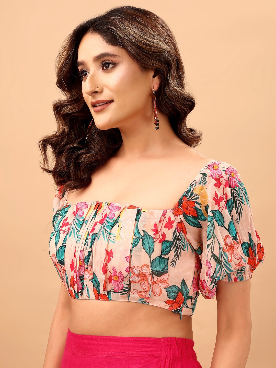 Woman wearing a floral top with a beige background