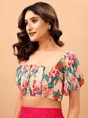 Woman wearing a floral top with a beige background