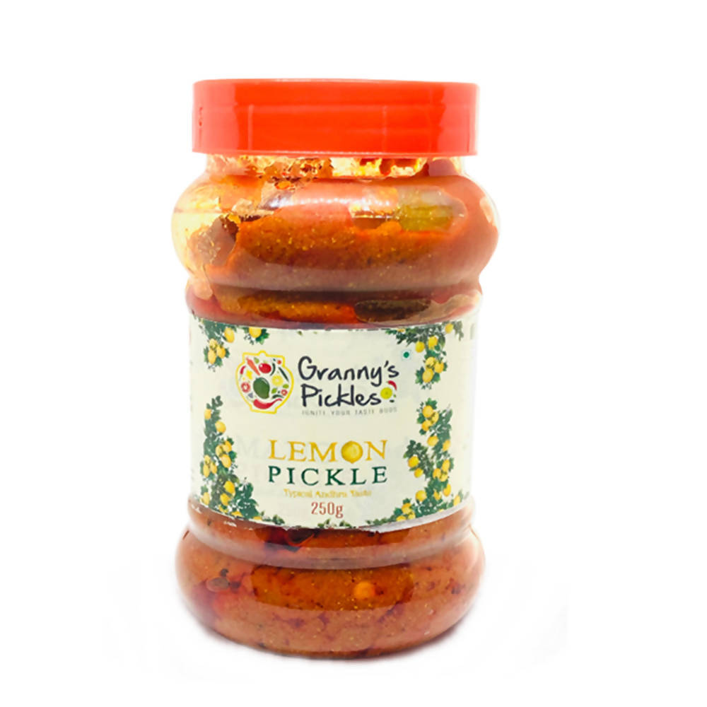 Jar of lemon pickle with a red lid on a white background