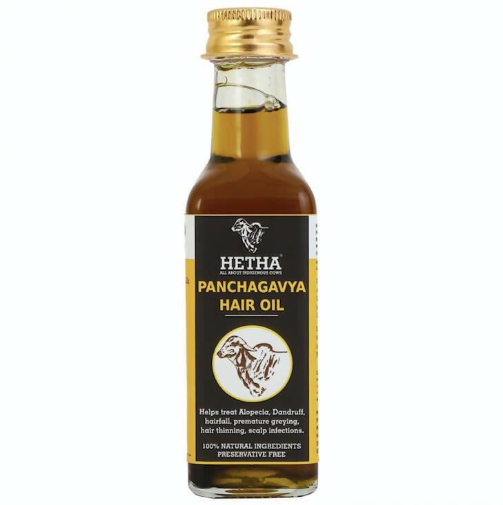 Bottle of Hetha Panchagavya Hair Oil with a gold cap on a white background