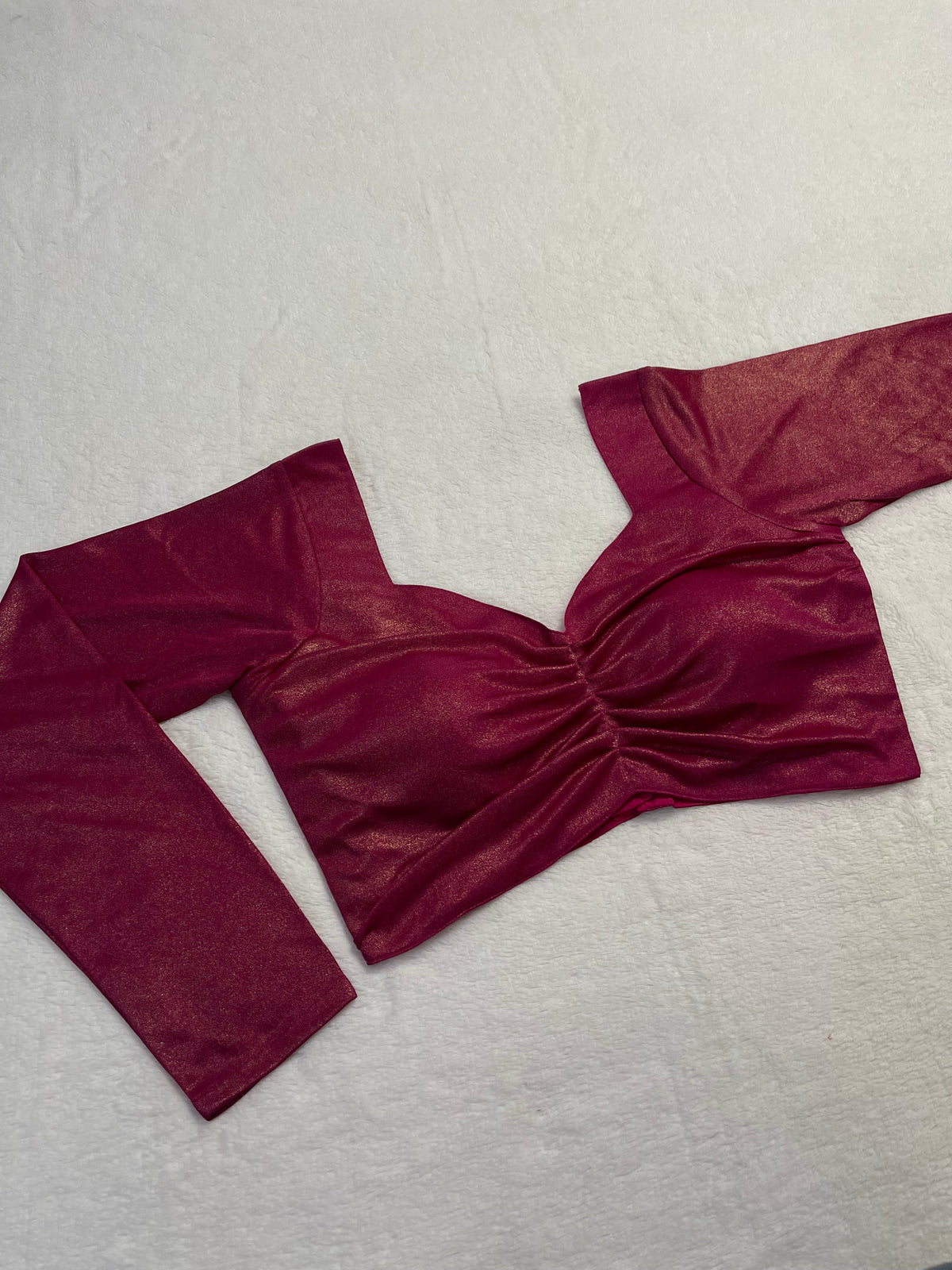 Red velvet garment on a light gray background
