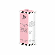 Box of anti-aging oil with pink and white design on a white background