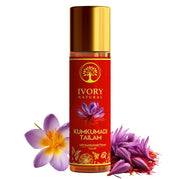 Bottle of Ivory Natural Kumkumadi Tailam with flowers on a white background