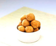 Bowl of fried dough balls on a white background