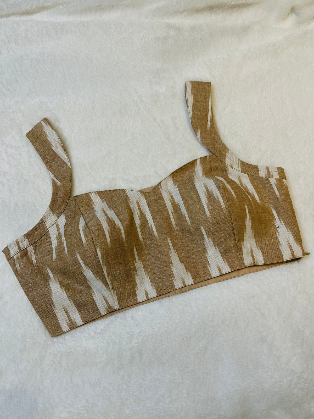 Brown and white patterned crop top on a light background