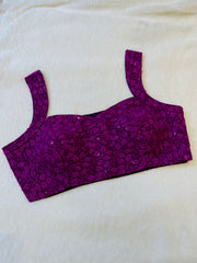 Purple floral-patterned top on a white background