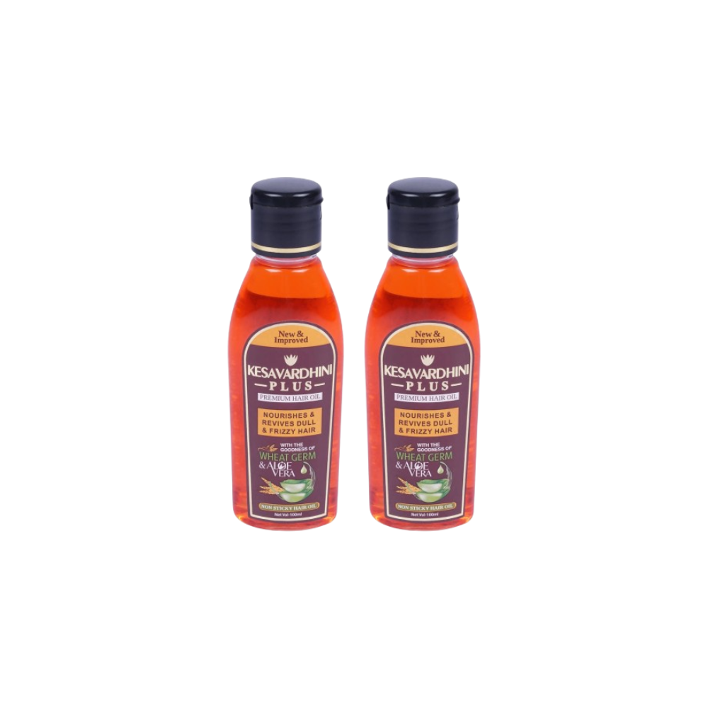 Two bottles of Kesavardhan Plus hair oil on a white background
