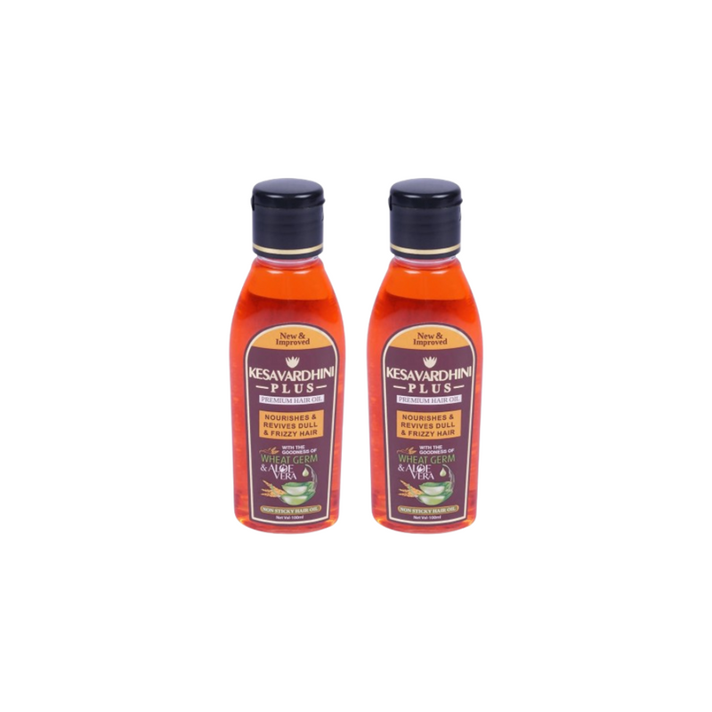 Two bottles of Kesavardhan Plus hair oil on a white background
