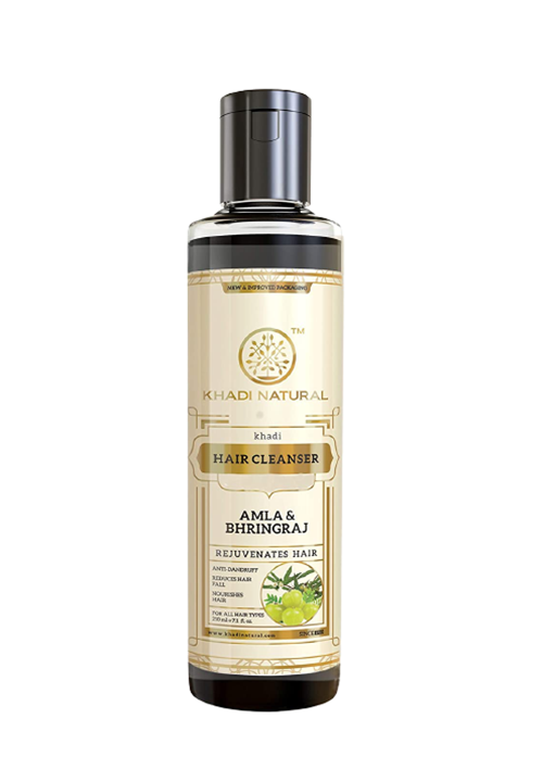 A bottle of Khadi Natural Ayurvedic Amla and Bhringraj Hair Cleanser/Shampoo with a black cap and a label that includes an image of the Amla and Bhringraj herbs.
