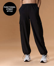Black cargo pants worn by a person on a beige background with 'Functional Street Style' text.