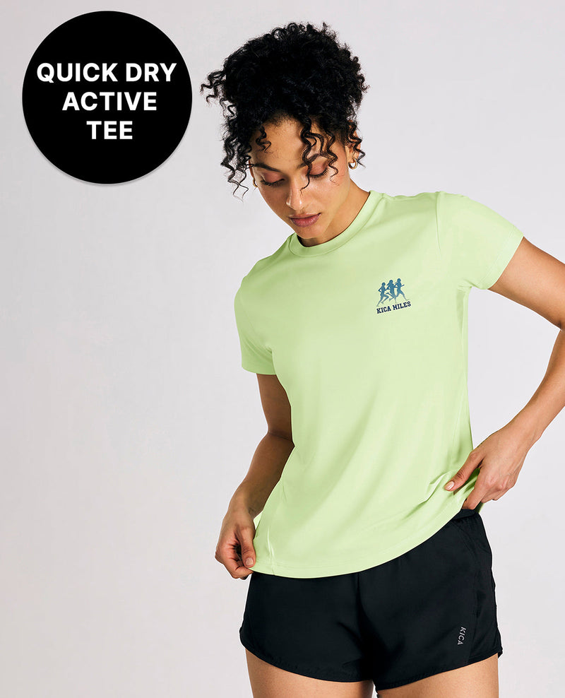 Person wearing a light green quick dry active tee with a logo, on a white background.