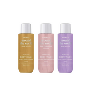 Three bottles of Klorane perfume body wash in different colors on a white background