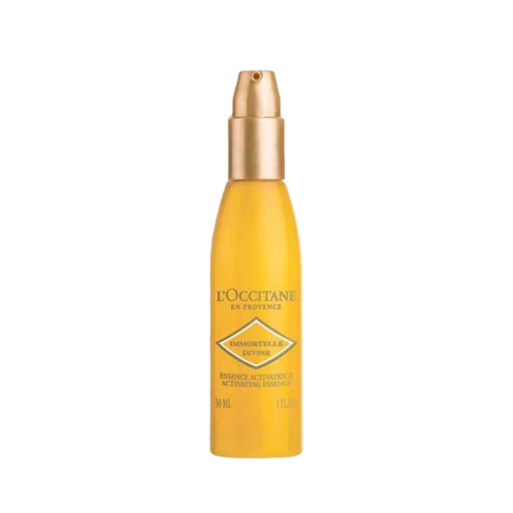 Yellow bottle with gold cap of L'Occitane product on a white background