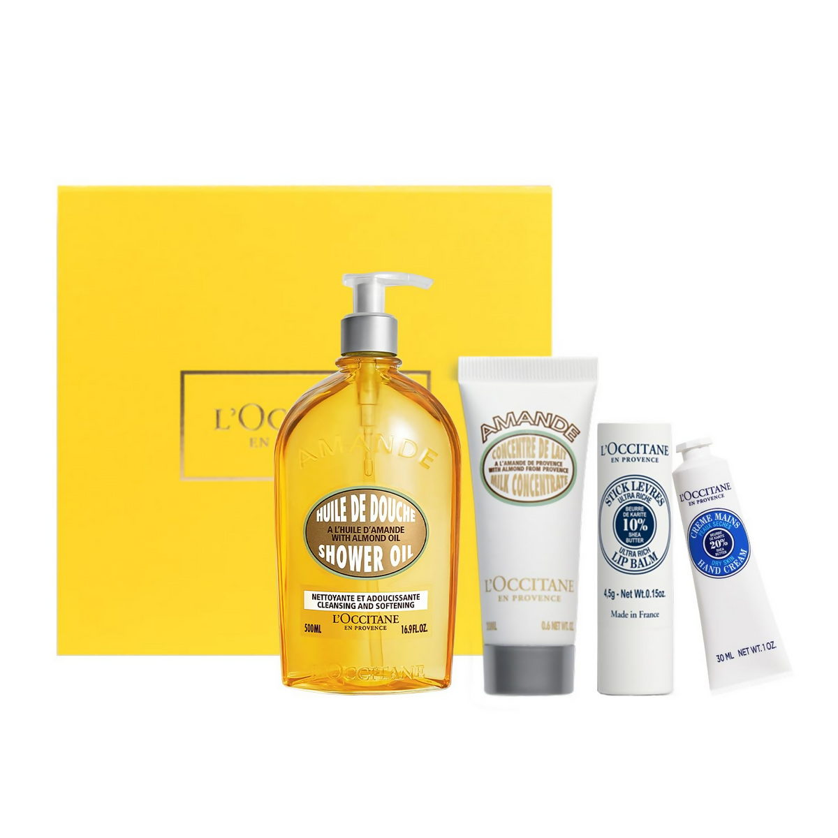 L'Occitane skincare products including a yellow shower oil bottle and white tubes on a white background.
