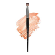 Makeup brush with black handle and silver ferrule, next to a swatch of peach-colored makeup on a white background.