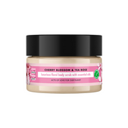 Jar of cherry blossom and tea rose body scrub with a pink label on a white background