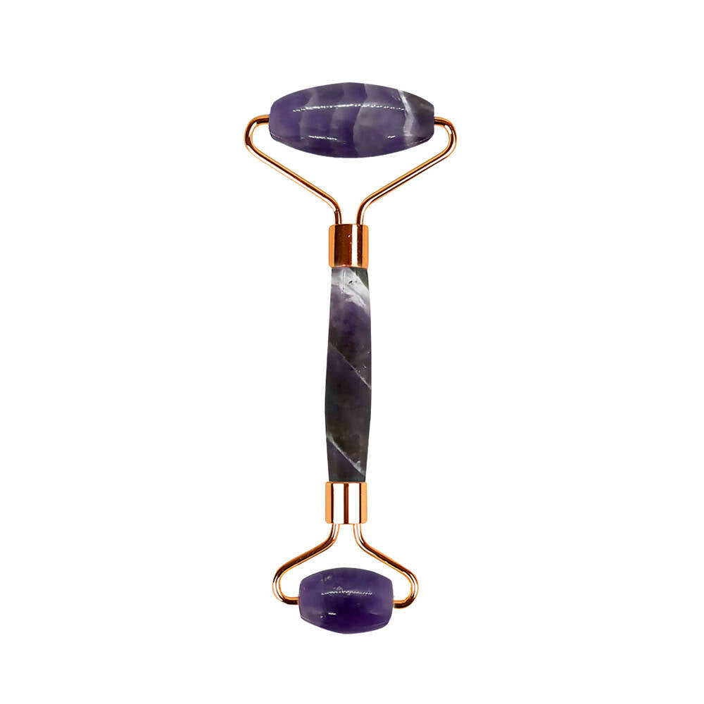 Amethyst facial roller on a white background