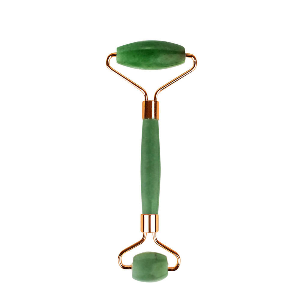 Jade facial roller with green stones on a white background