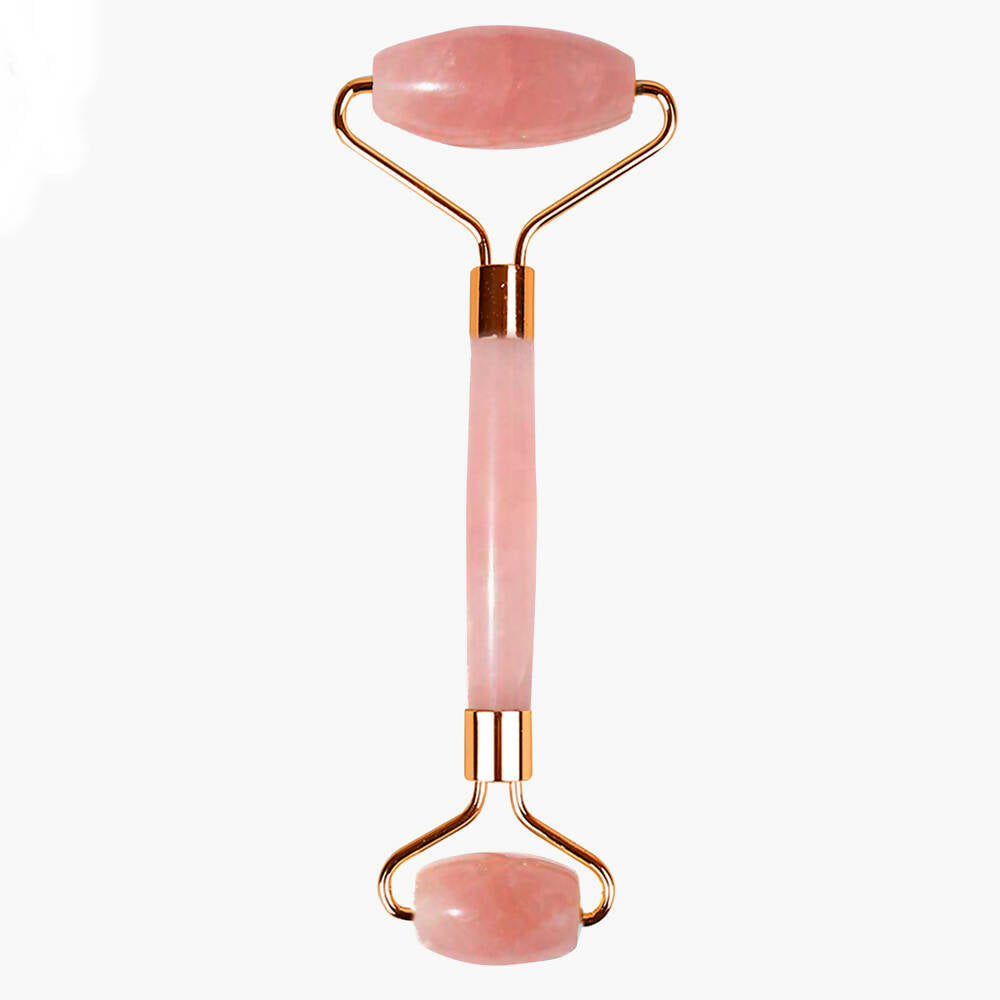 Rose quartz facial roller with gold accents on a white background