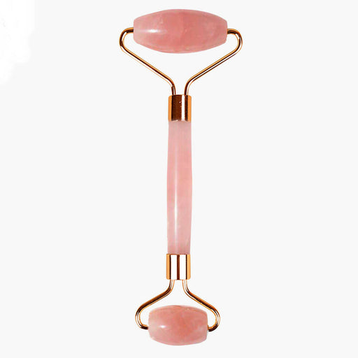 Rose quartz facial roller with gold accents on a white background