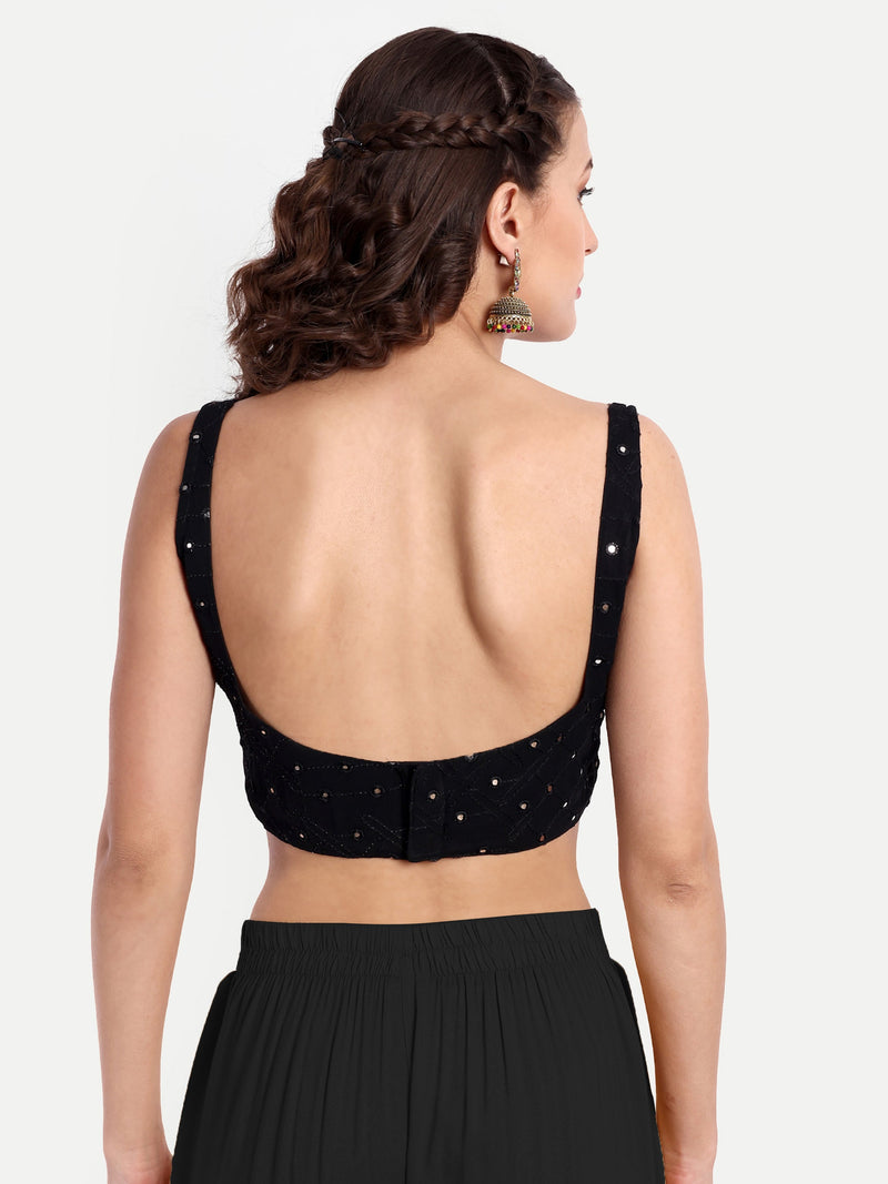 Black blouse with open back design on a white background