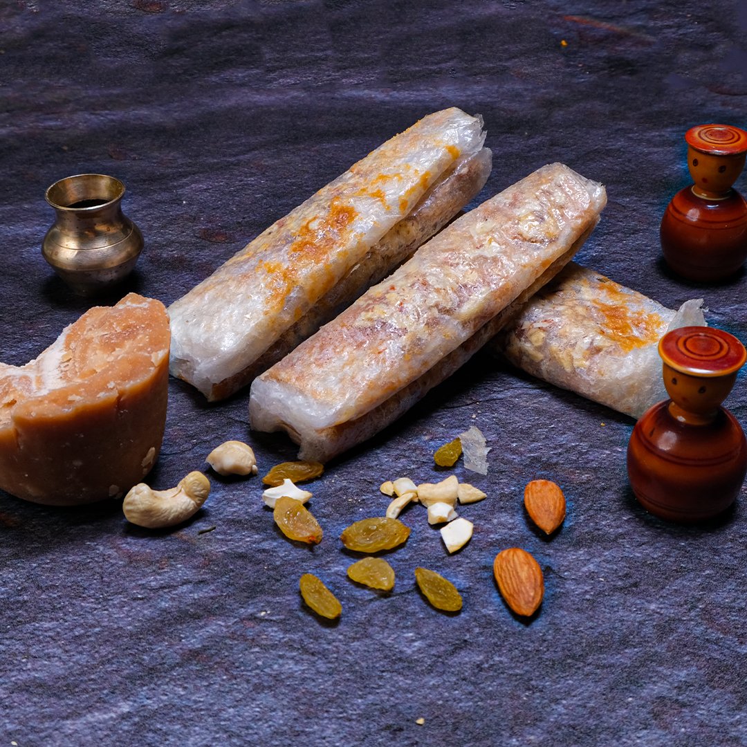 Rolled snacks with nuts on a dark surface