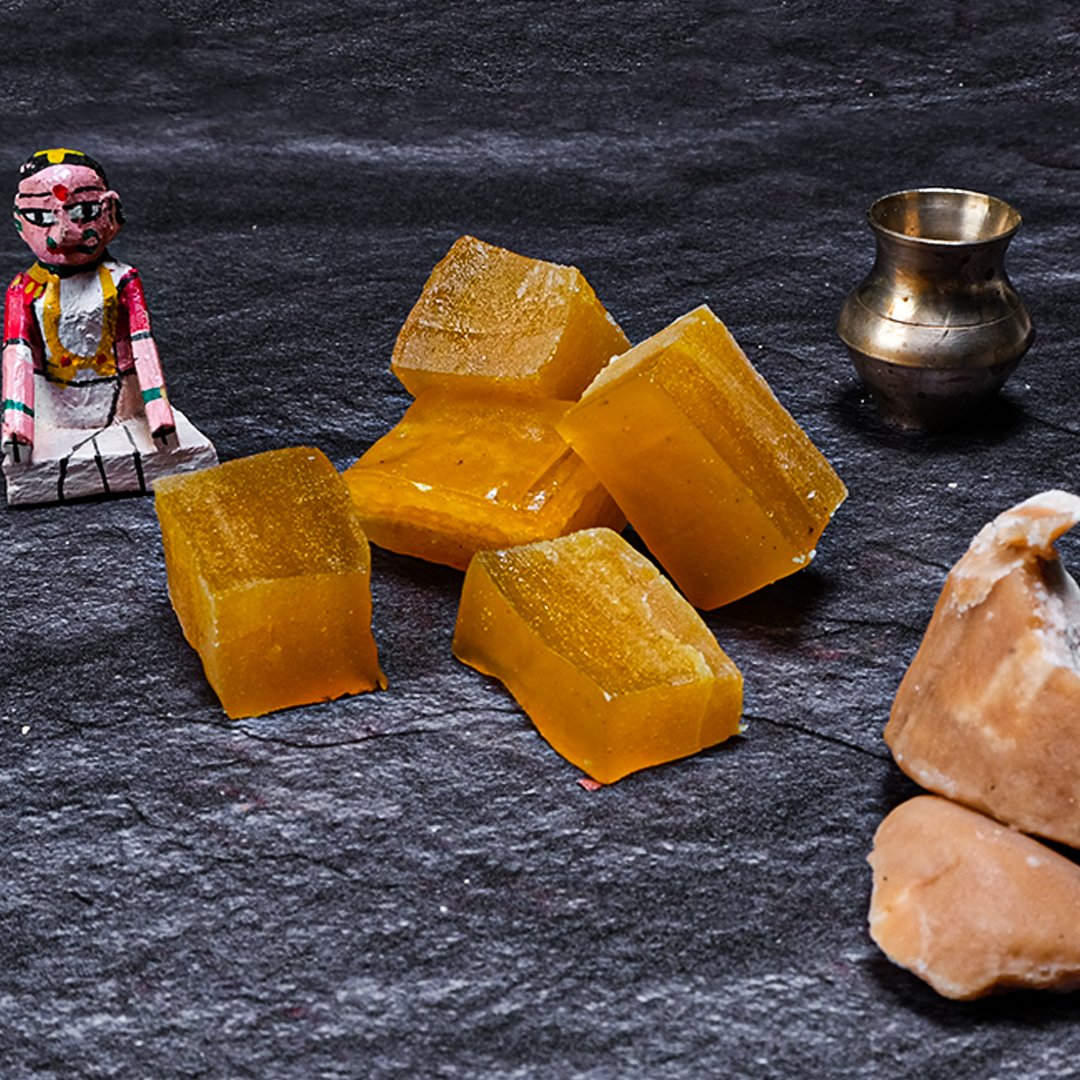 Yellow blocks on a dark surface with a small figurine and metallic container.