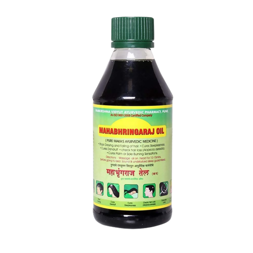 Bottle of Mahabhhringaraj Oil with green cap on a white background